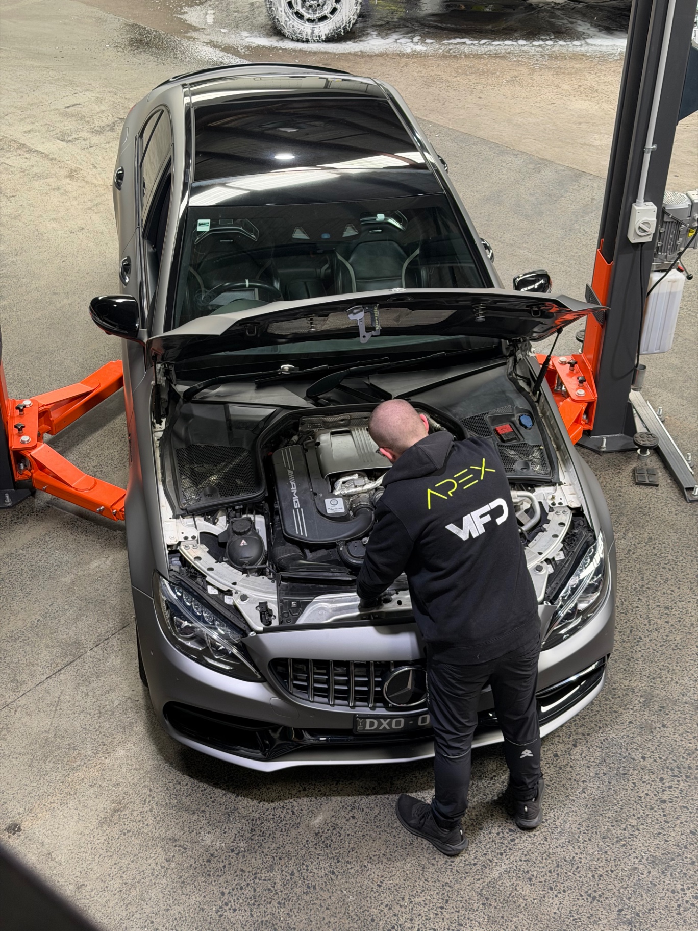 Technician working on an AMG C63 at Apex
