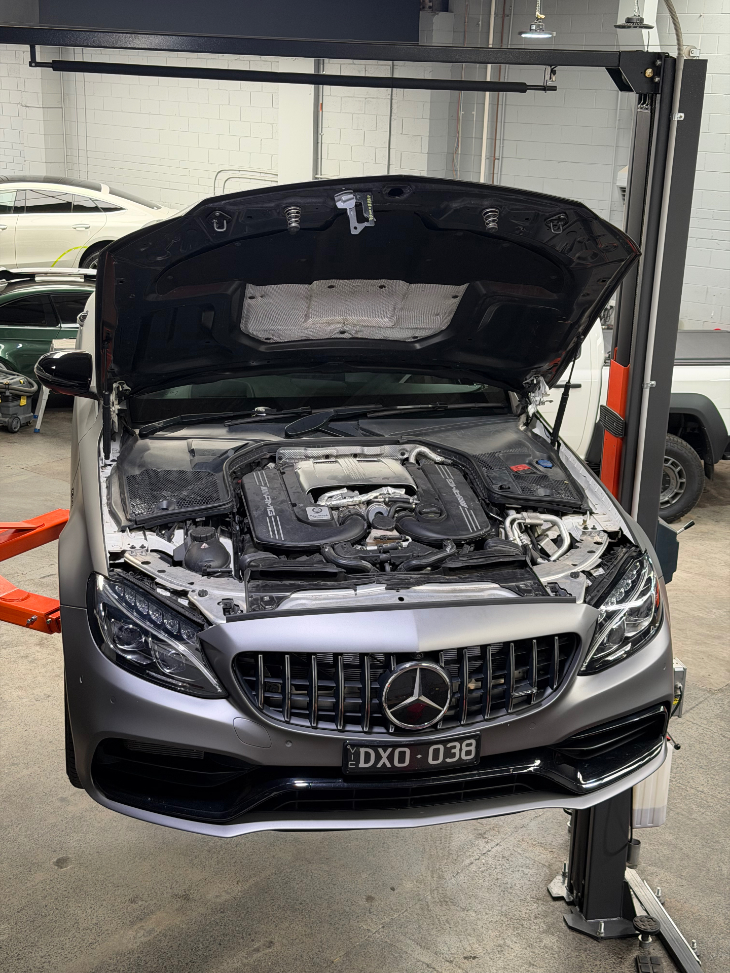 AMG C63 engine bay on the hoist at the Apex Performance Tuning workshop in Wantirna South