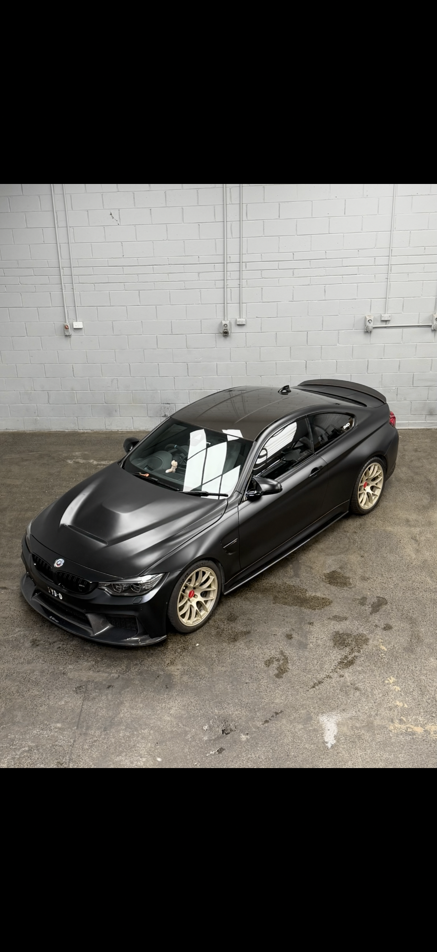 Matte black BMW M4 in the Apex Melbourne workshop